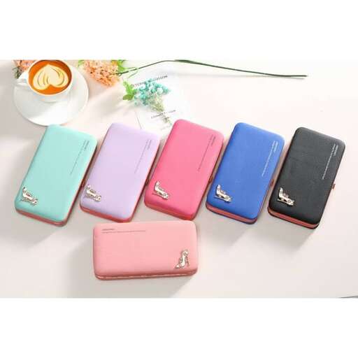 a table topped with three different colored cell phones.