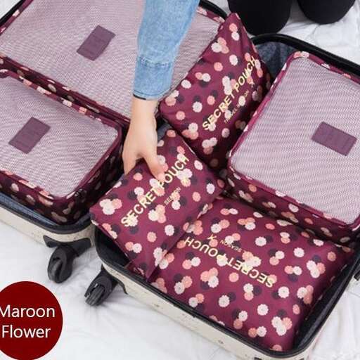 a person holding a suitcase with a flower on it.