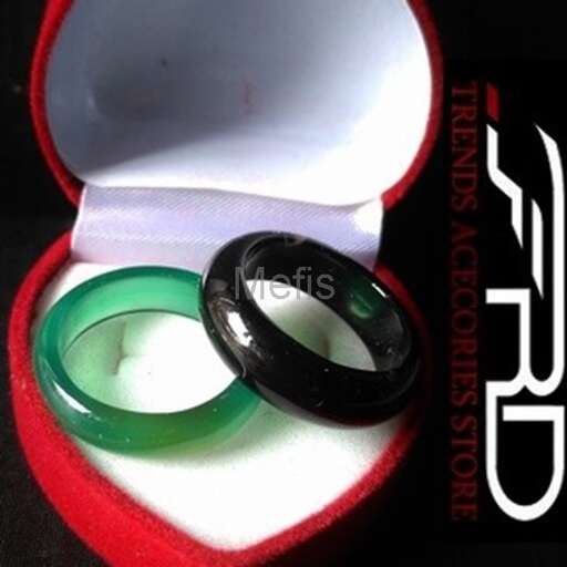 a ring in a box with a green ring inside.