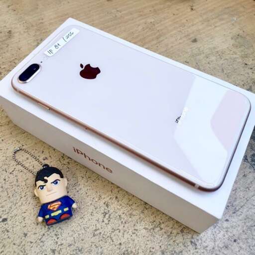 a small toy figure next to an apple computer.