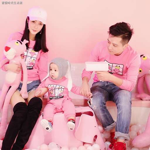 a man and two girls sitting on a couch.