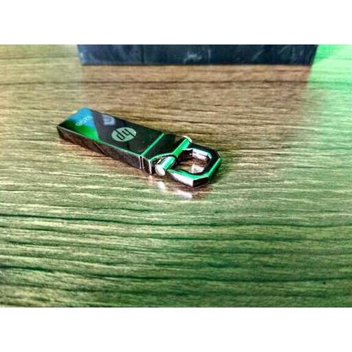 a green and black cell phone on a table.