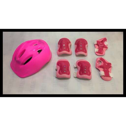 a pink plastic helmet with a face on it.