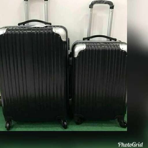 a black suitcase with a black handle and a black suitcase on the bottom.