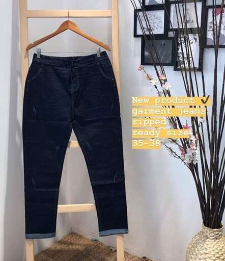 a pair of jeans are shown with a plant.