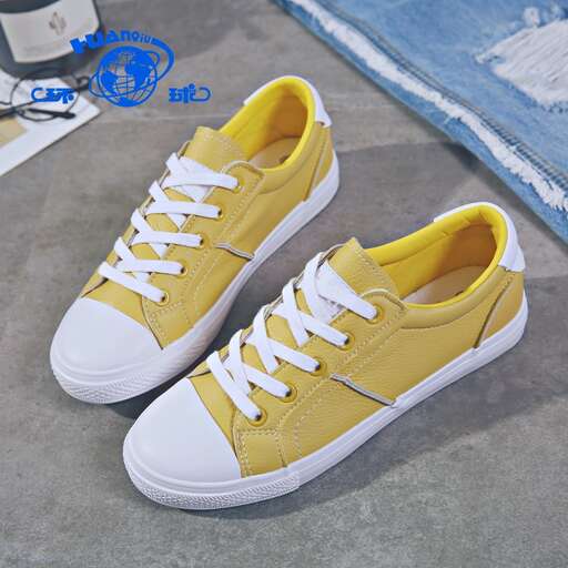 a pair of new yellow and white sneakers