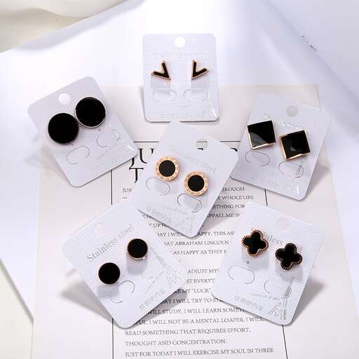 a table with several different types of earrings on it.