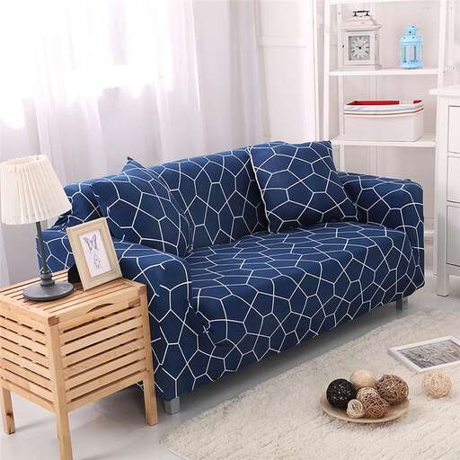 a blue couch with a lamp and a table