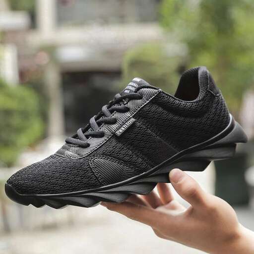 the shoe is a sneaker that is made of leather.