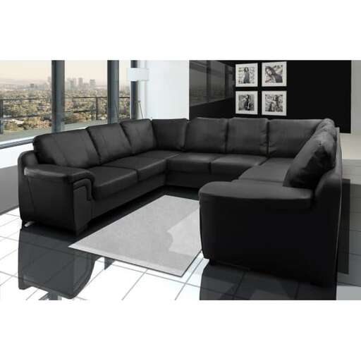 a black couch with a white rug and a black rug