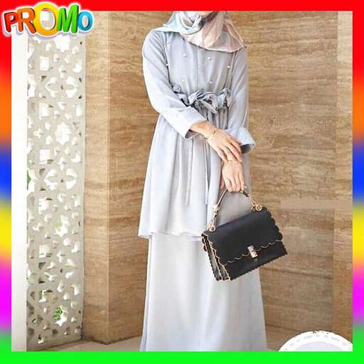 a long sleeved white dress with a black handbag