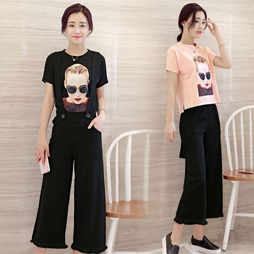 a woman in black with a pink shirt and black pants