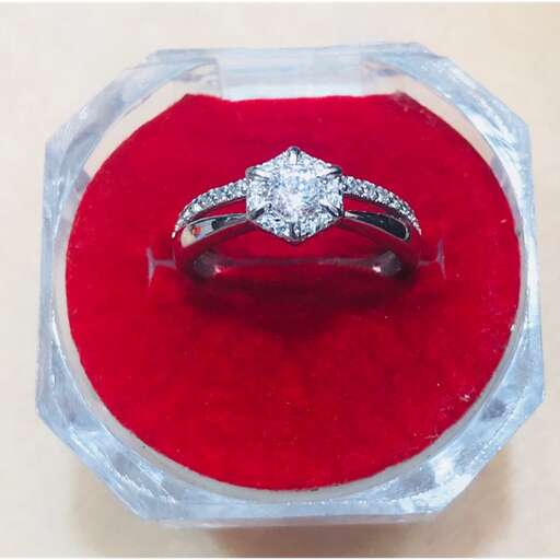 a diamond ring in a red velvet box