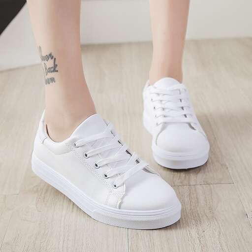 white sneakers with a tattoo