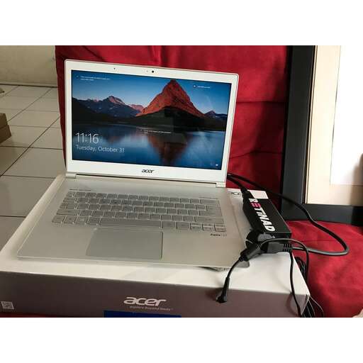 a laptop computer sitting on top of a box.