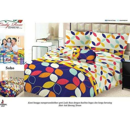 a bed with a colorful bedding and a black nightstand.