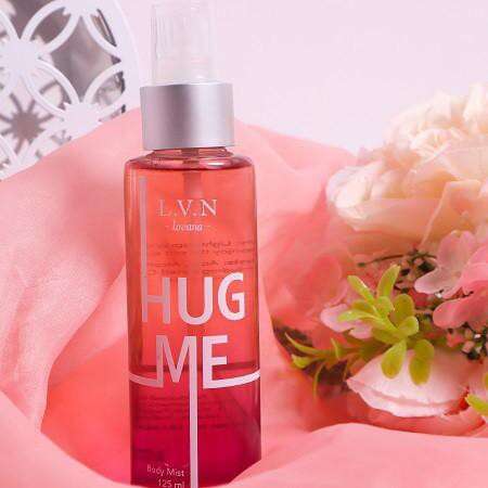 a bottle of perfume in pink