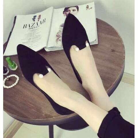 a pair of black high heeled shoes with a black dress.