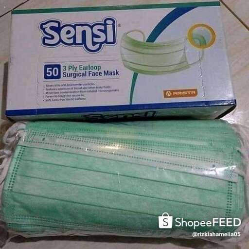 a package of green tissue paper with a plastic bag in it.