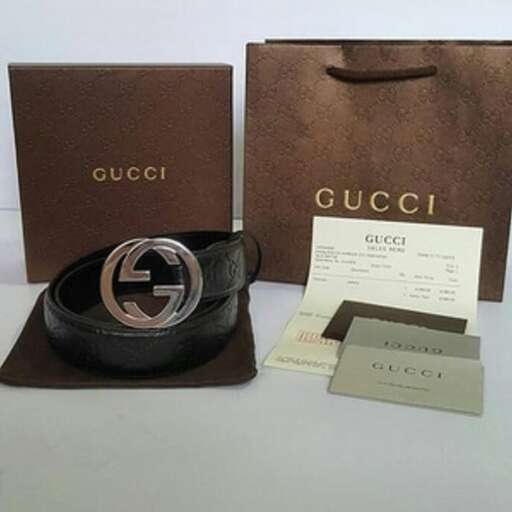 a black leather belt and a brown bag with a gold logo on it.