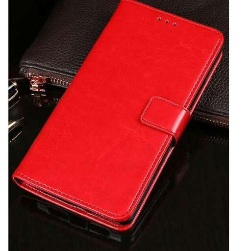 a red and black cell phone case sitting on a black leather case.