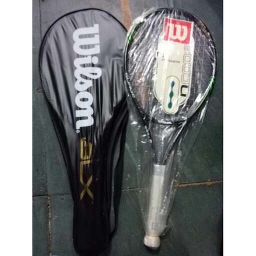 a tennis racket and a plastic bag on the ground.