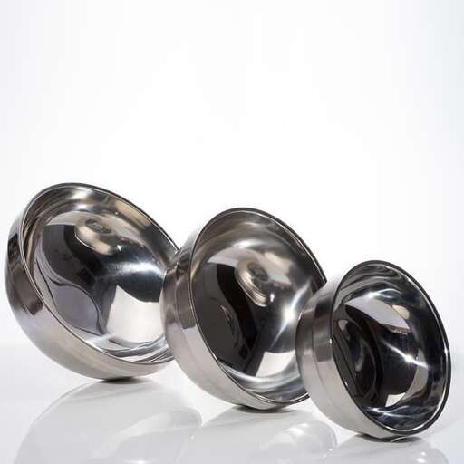 a pair of silver spheres on a white surface.