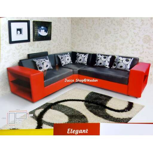 a modern sofa with a black and white rug.
