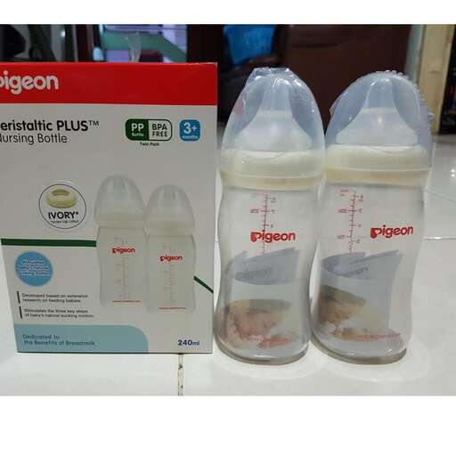 two bottles of baby bottles sitting on a table.