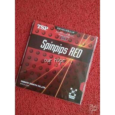 a red and black book on a red carpet.