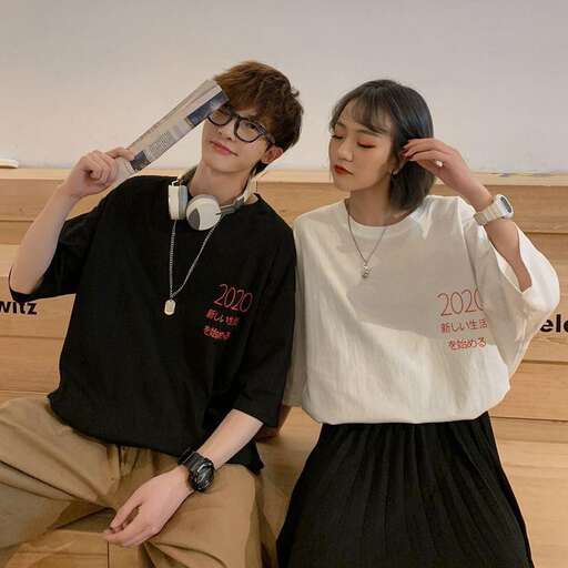a boy and girl pose for a picture in the classroom.