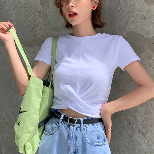 white tee with a green bag and a pair of blue jeans.