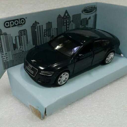 a toy car in a box with a city in the background.