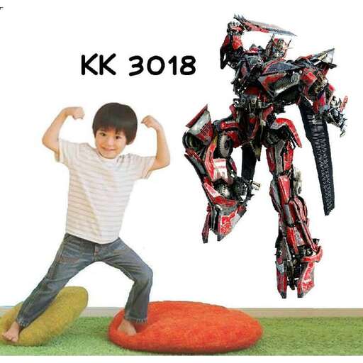 a boy standing on a mat next to a giant robot.