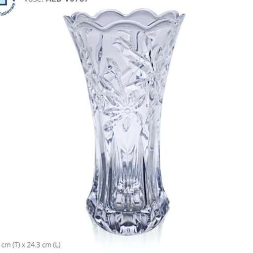 a tall glass vase with a design of a tree on top.