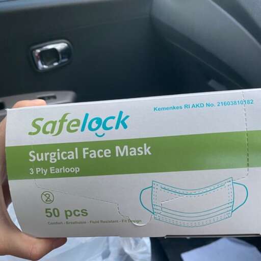 a box of facial masks is shown in a car.