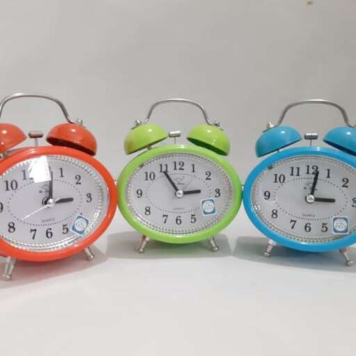 four colorful alarm clocks with different colored faces.