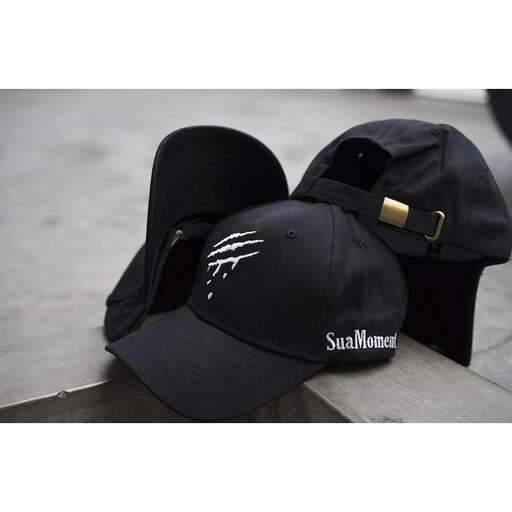 a black baseball cap with a gold buckle.