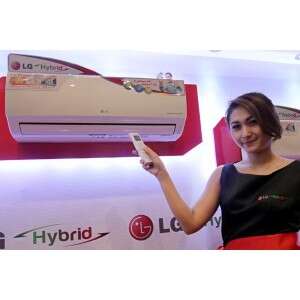 a woman holding a white wii controller in her hand.