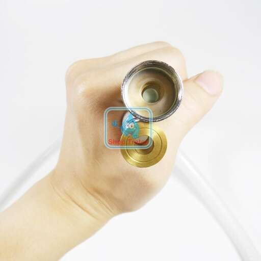 a hand holding a bottle of oil
