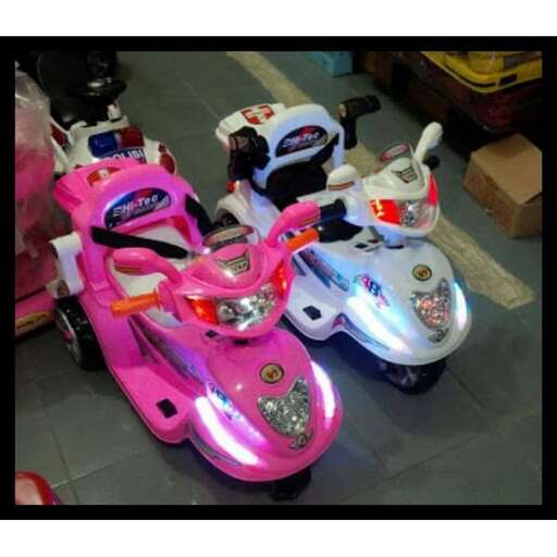 a couple of pink scooters parked in a store.