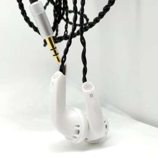 a white telephone with a cord attached to it.