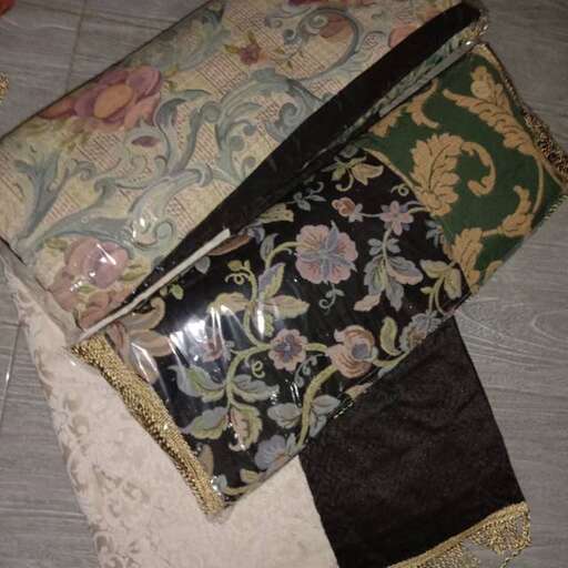 a black and green bag with a floral design.