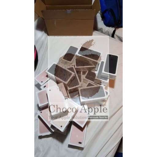 a box of cards is broken on a bed.