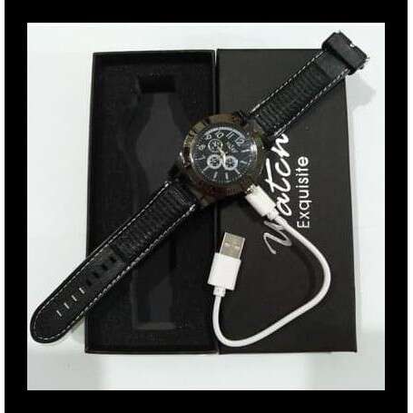 a watch with a wrist strap on a table.