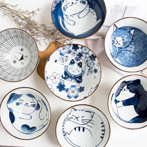 a collection of blue and white bowls and plates in a shop in the french quarter in the south village of france.