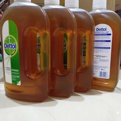 a white counter top with bottles of liquid on it.