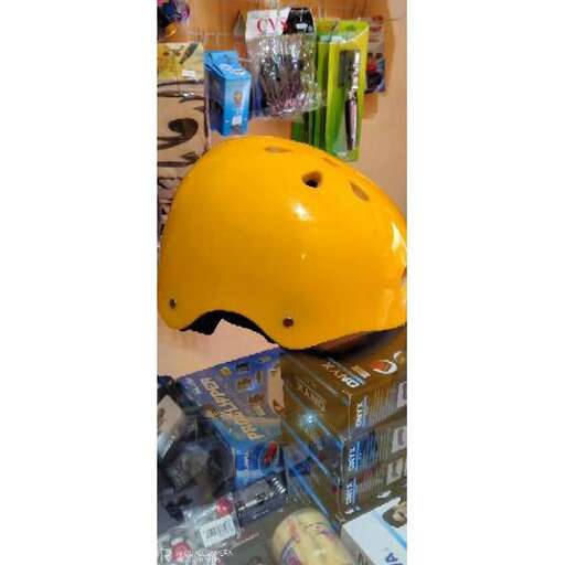 a yellow hard hat sitting on top of a pile of boxes.