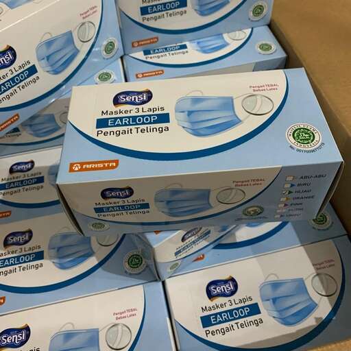 a box of toothpaste is stacked on a cardboard box.