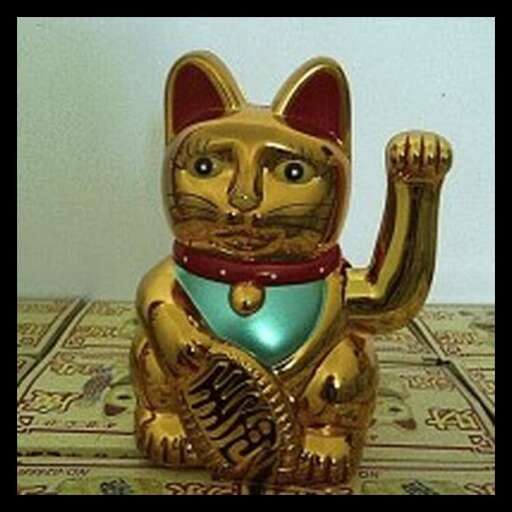 a cat statue with a glove on it